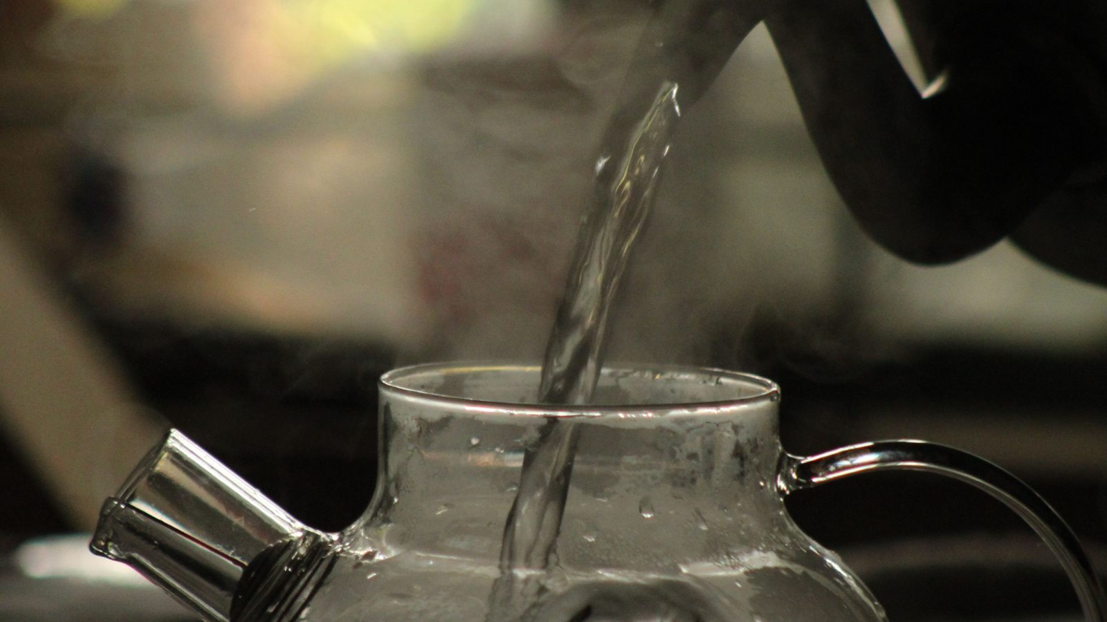 A kettle boiling for calming rose lavender and chamomile herbal tea