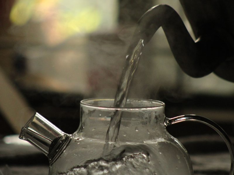 A kettle boiling for calming rose lavender and chamomile herbal tea